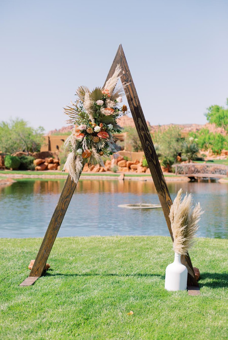 Wedding arch set up with flowers next to water
