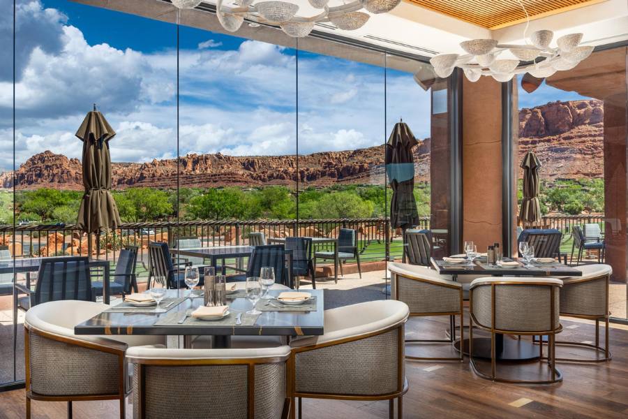 Interior of Sol Mesa restaurant at The Inn at Entrada with warm ambiance and views of the surrounding red rock landscape in St. George, Utah