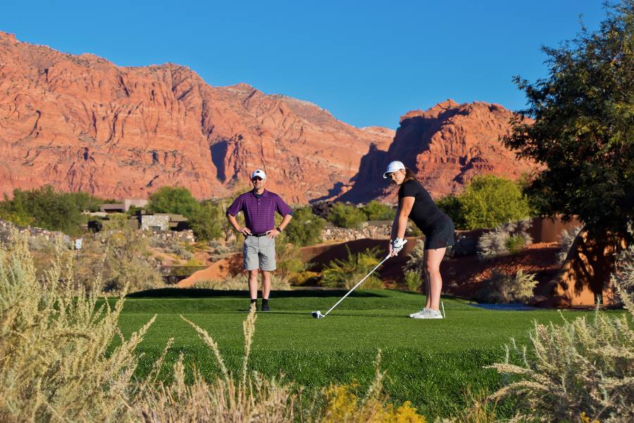 Desert golf course at The Inn at Entrada surrounded by lava rock and sandstone cliffs in St. George, Utah.