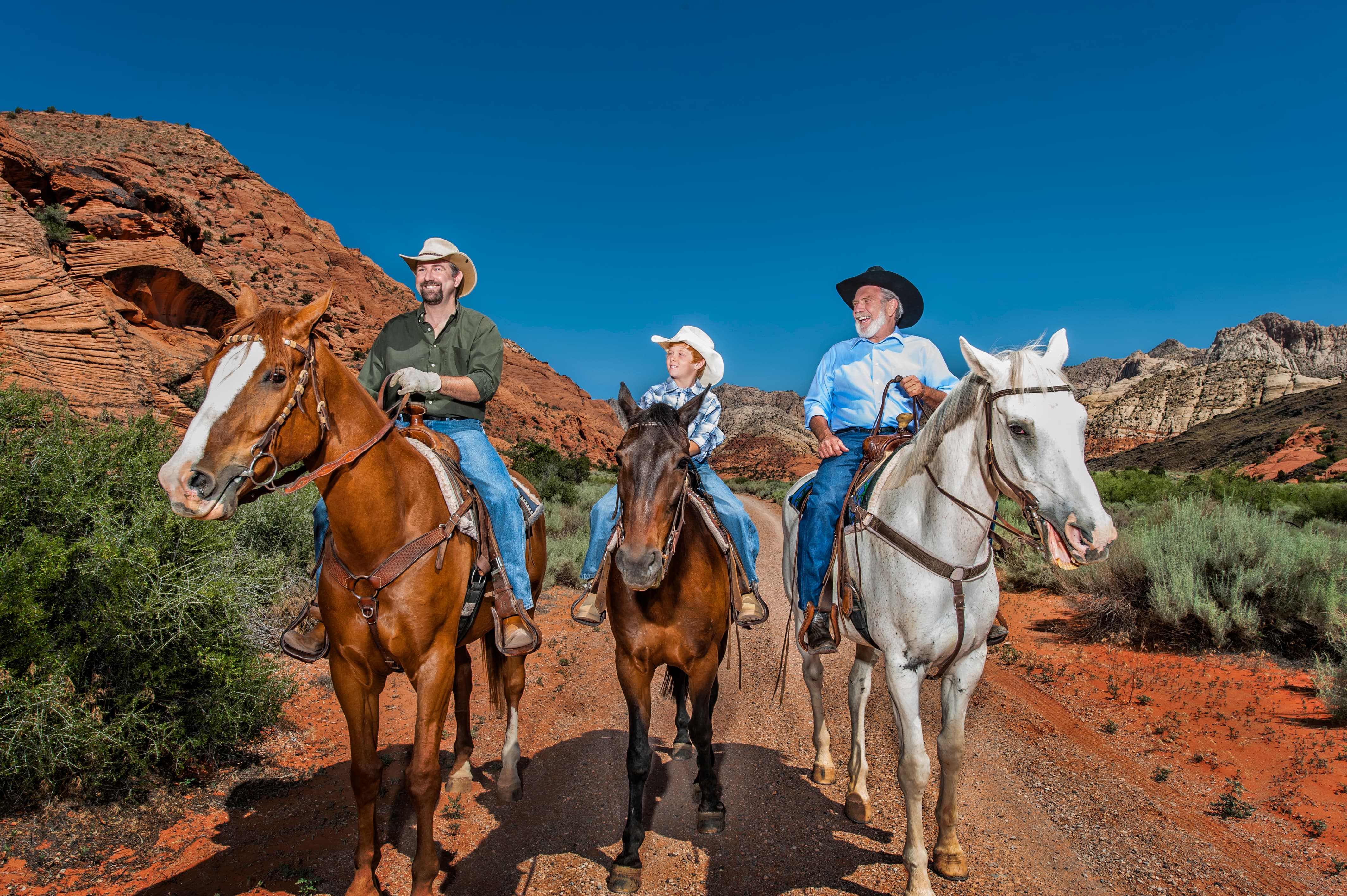 Three people riding horses