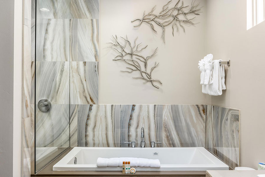 Luxury bathroom equipped with standalone walk-in shower and jetted whirlpool tub